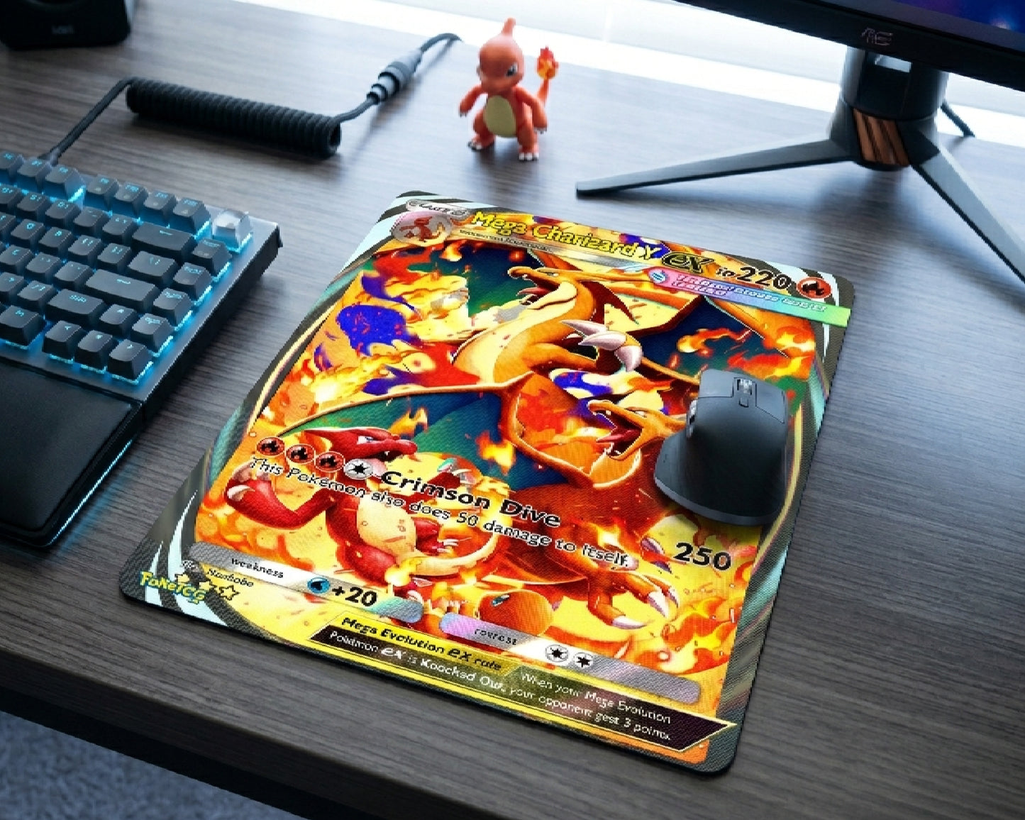 Mega Charizard Y Pokémon card style gaming mouse pad with fiery artwork placed on a modern gaming desk setup with RGB keyboard and wireless mouse