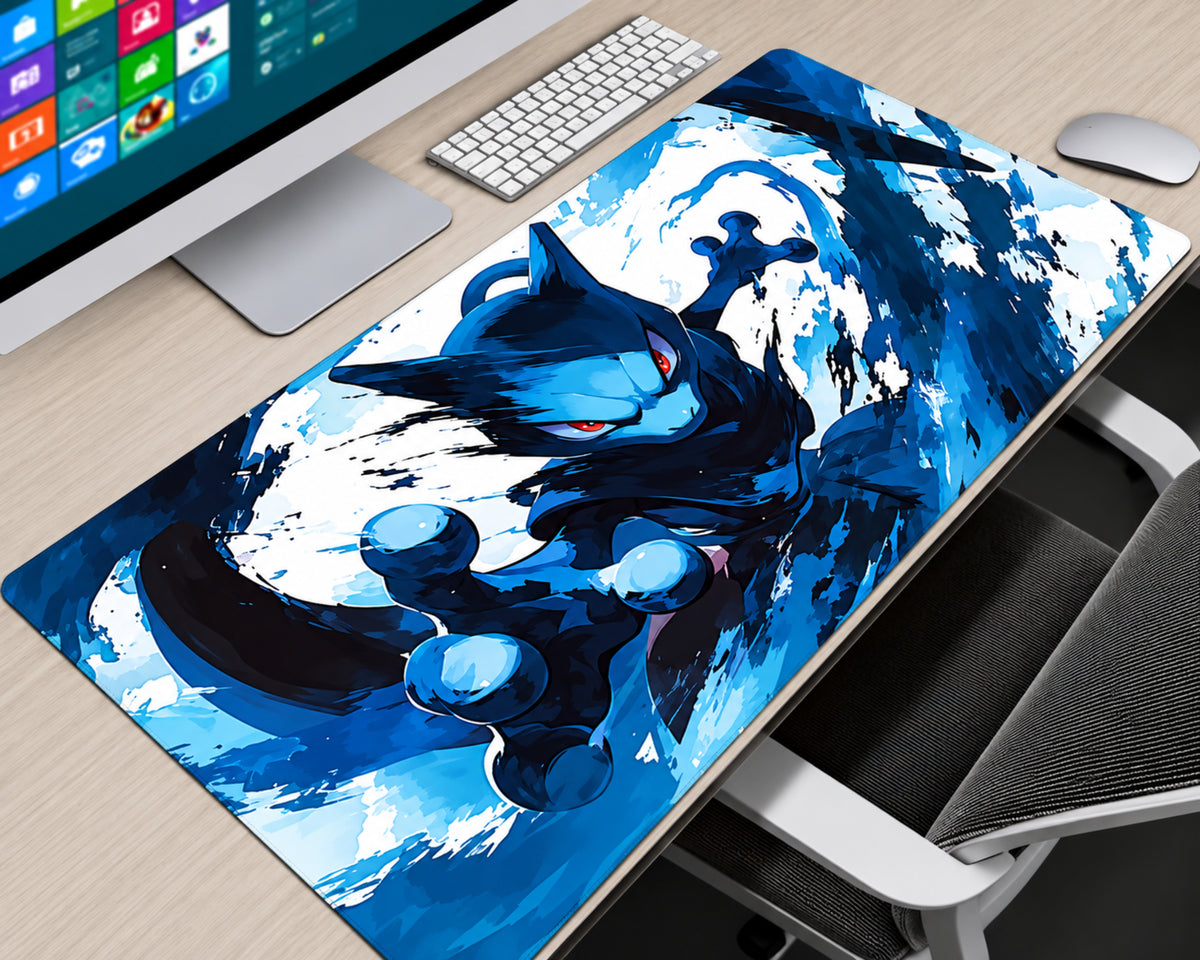 A large desk mat featuring a dynamic blue anime-style cat illustration, shown on a light wood desk next to a keyboard, mouse, and computer monitor.