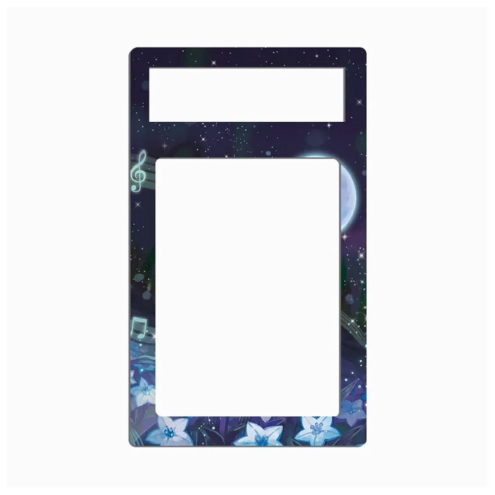 A decorative rectangular frame or plate with a dark galaxy print, featuring a treble clef, music notes, stars, and blue flowers around the border, with two blank white rectangular cutouts at the top and center.