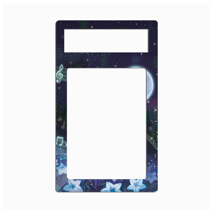 A decorative rectangular frame or plate with a dark galaxy print, featuring a treble clef, music notes, stars, and blue flowers around the border, with two blank white rectangular cutouts at the top and center.