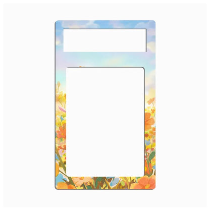 A vertical rectangular decorative frame or insert with rounded corners, featuring a pastel sky background and orange wildflower illustrations along the bottom and right edges. The top portion has a smaller horizontal cutout, and the center is a large blank white rectangle.