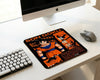 Minimal white workspace with Son Goku Dragon Ball themed mouse pad, wireless gaming mouse, compact mechanical keyboard, and modern desktop computer setup