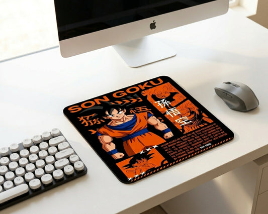 Minimal white workspace with Son Goku Dragon Ball themed mouse pad, wireless gaming mouse, compact mechanical keyboard, and modern desktop computer setup