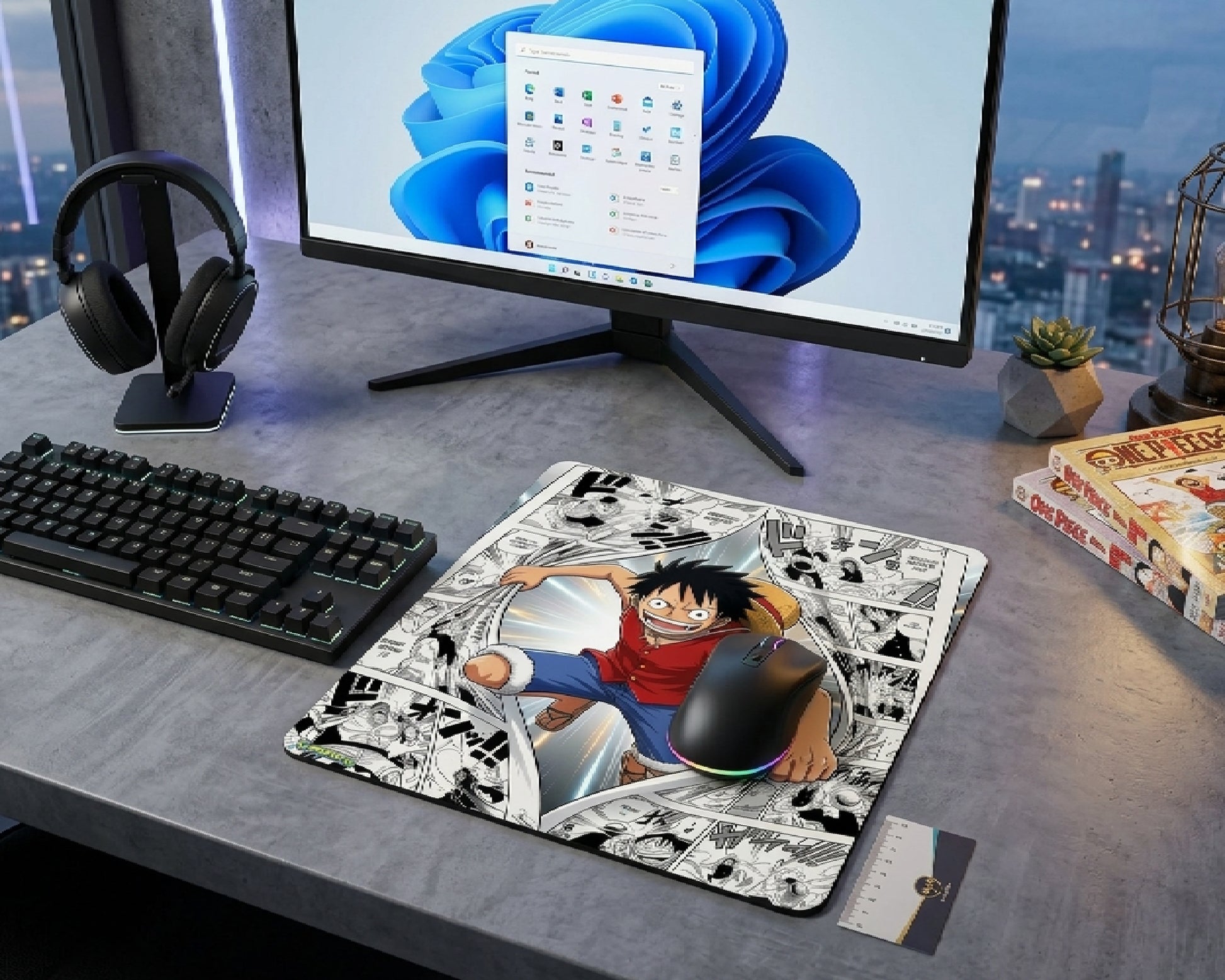 Modern gaming desk setup featuring Monkey D. Luffy manga collage mouse pad, RGB mouse, widescreen monitor, headphones, and One Piece manga volumes