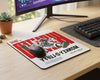 Stylish Monkey D. Luffy wanted poster themed anime mouse pad with bold red typography, placed on a minimalist gaming desk beside mechanical keyboard and widescreen monitor