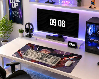 A modern gaming desk setup featuring a large anime-themed desk mat with a keyboard and mouse, a curved monitor, a desktop computer tower, and various desk accessories in a brightly lit room.