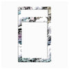 A rectangular picture frame with a decorative border featuring black and white comic-style illustrations, light blue accents, and small pink details, shown against a plain white background.