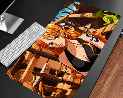 Nami-inspired One Piece anime gaming mouse pad featuring an orange-haired character with a blue shoulder tattoo and black outfit, posed against a detailed wooden ship background with tropical greenery.