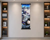 A vertical anime-style wall scroll poster featuring a white-haired female character in a blue and gray sci-fi setting, displayed on a beige wall between two built-in wooden shelves with books and plants.