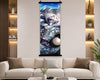 A vertical anime wall scroll poster featuring a character in blue and white armor, displayed in a modern living room setting above a white sofa with decorative pillows.
