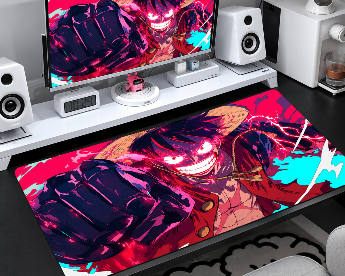 Anime gaming mouse pad featuring a Gear 5-inspired Luffy character with an oversized punch, glowing energy effects, and vivid neon pink, purple, red, and cyan artwork, displayed on a modern gaming desk.