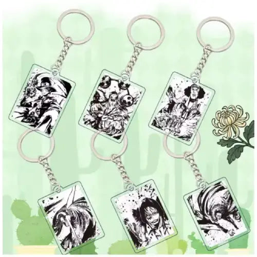 Six rectangular acrylic keychains with silver metal key rings and chains, each featuring black-and-white manga-style character illustrations, arranged on a pale green background with a white flower graphic.
