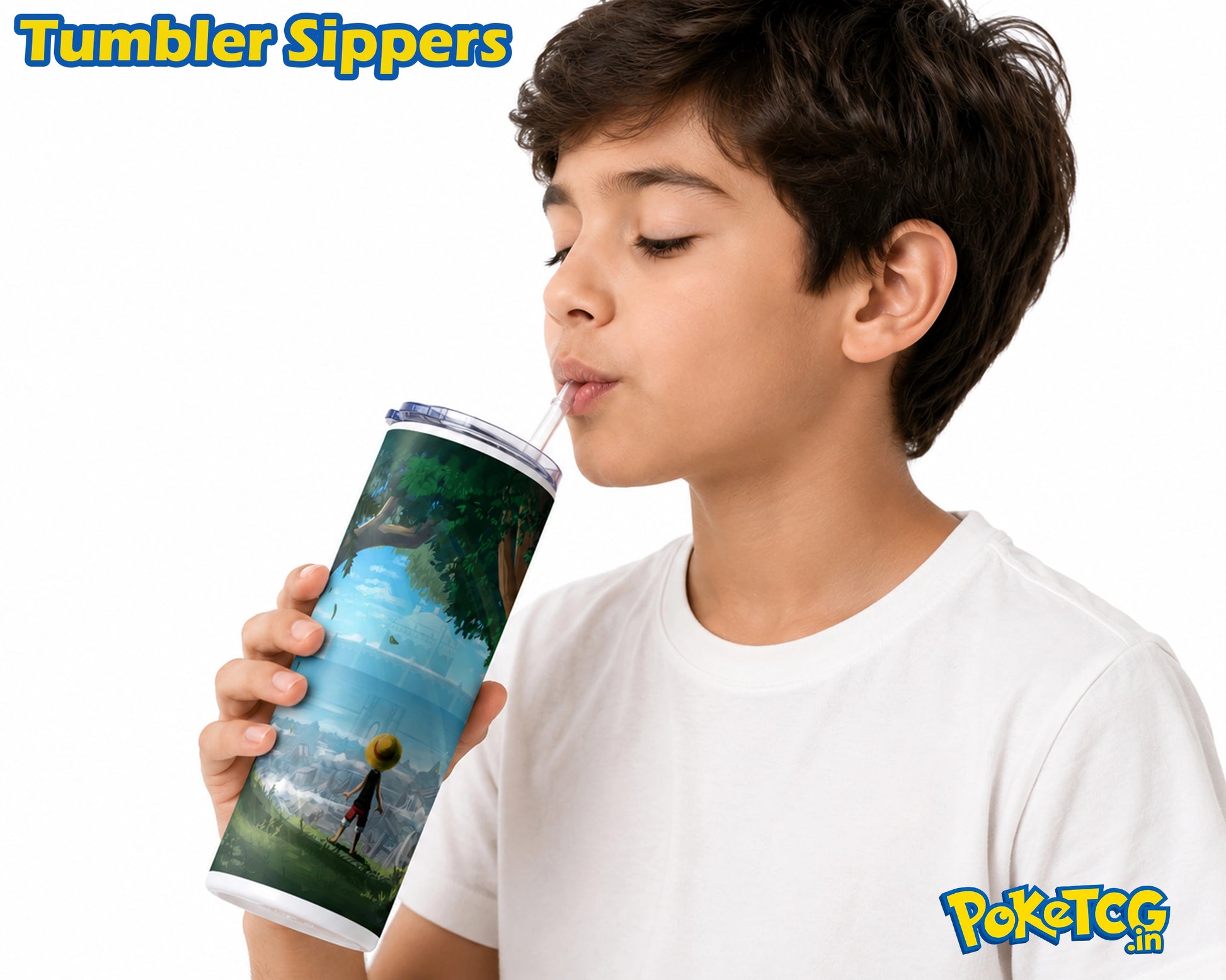 A boy in a white t-shirt holds a tall, cylindrical tumbler with a clear lid and straw, drinking from it. The tumbler features a colorful printed design depicting a fantasy landscape with a character and a yellow ball.