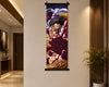 A vertical anime wall scroll featuring a dynamic character illustration in red, black, blue, and gold tones, hanging on a beige wall in a modern interior hallway with wood slat paneling and a potted plant.