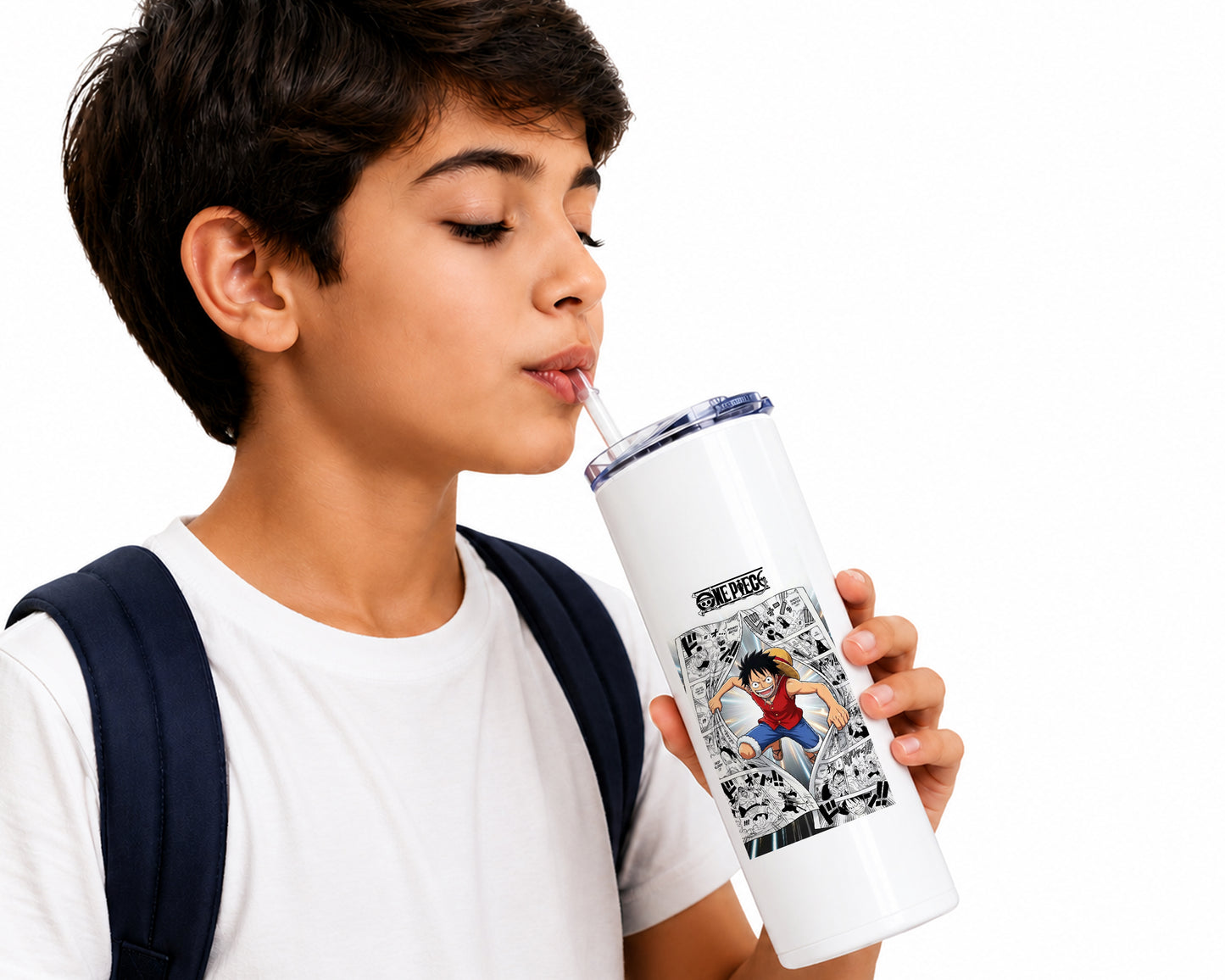 A boy with short dark hair, wearing a white t-shirt and a navy backpack strap, holds a white insulated travel tumbler with a straw. The tumbler features a black and white comic book style graphic of a character with the text 'ONE PIECE' on a clean white background.