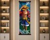 A vertical wall scroll poster featuring the anime character Monkey D. Luffy from One Piece, displayed hanging on a beige wall between two illuminated bookshelves.