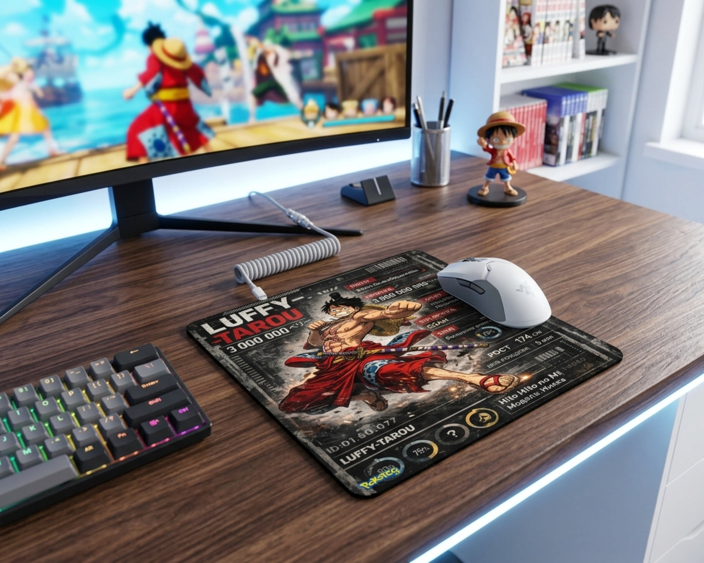 One Piece Luffy-Tarou anime gaming mouse pad on wooden desk beside RGB keyboard, white gaming mouse, and anime-themed monitor setup