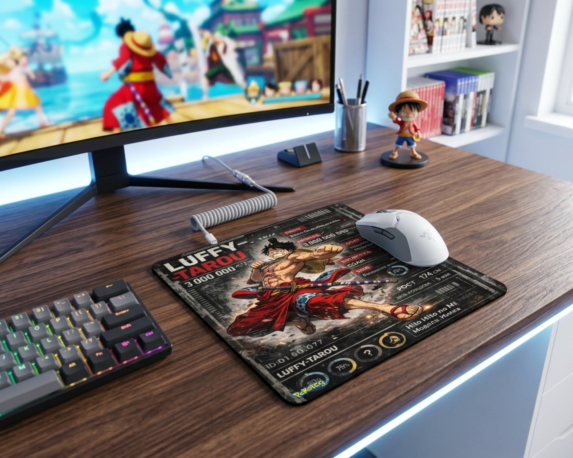 One Piece Luffy-Tarou anime gaming mouse pad on wooden desk beside RGB keyboard, white gaming mouse, and anime-themed monitor setup
