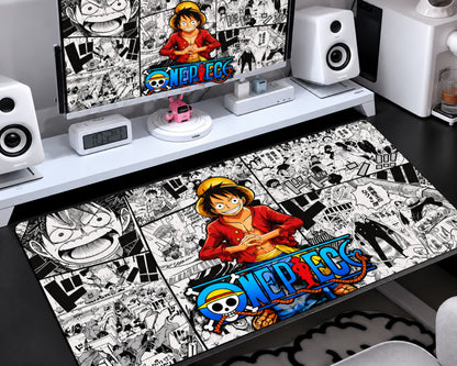 Gaming mouse pad featuring a smiling straw-hat anime pirate in a red outfit, colorful blue-and-yellow lettering, and a detailed black-and-white manga panel collage.