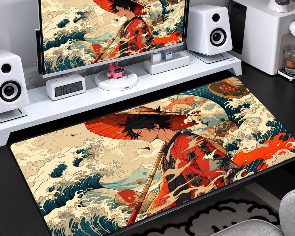 Anime-inspired extended gaming mouse pad featuring a black-haired samurai character in a red outfit holding a red umbrella, surrounded by traditional Japanese ocean waves in teal, cream, and orange, displayed on a desktop gaming setup.