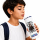 A young boy with short dark hair, wearing a white t-shirt and a navy backpack strap, is shown drinking from a white insulated tumbler with a clear straw. The tumbler features a black-and-white comic-style graphic of a superhero and a colorful 'SMOKY' logo at the bottom.