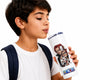 A young boy with dark hair, wearing a white t-shirt and a navy backpack strap, holds a white insulated tumbler with a clear lid and straw. The tumbler features a graphic print of characters from the anime series One Piece, including Sanji and Nico Robin, with the 'One Piece' logo at the bottom.