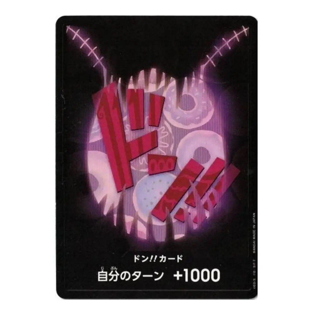 A Japanese Don Card trading card featuring a stylized graphic of a stitched, stitched-faced creature in red, pink, and white on a black background, with Japanese text at the bottom indicating a turn bonus of +1000.