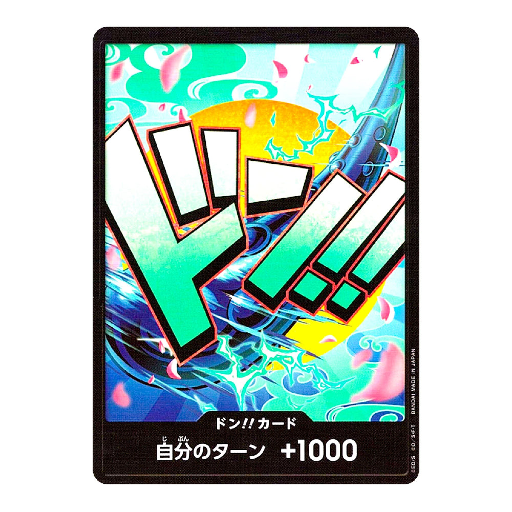 A collectible Japanese trading card with a black border and dynamic anime-style artwork featuring large green and white 'DORA!' lettering over a colorful blue, yellow, and pink background. The bottom text reads 'DON!! CARD' and '自分のターン +1000'.