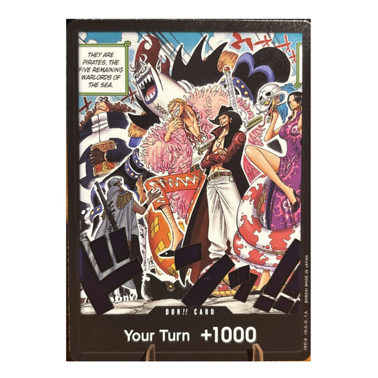 A One Piece trading card featuring a colorful anime illustration of the Pirate King and other sea warriors, with the text 'Your Turn +1000' at the bottom.