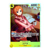 A collectible anime trading card featuring the character Kora from 'My Dress-Up Darling' in a pink dress, seated at a desk with a coffee cup. The card has a light blue border, a yellow health bar at the bottom, and Japanese text, with the number 6000 in the top right.