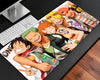 One Piece Straw Hat Crew gaming mouse pad featuring a group of smiling anime pirate characters, including Luffy, Zoro, Nami, and crew-inspired characters, on a white background.