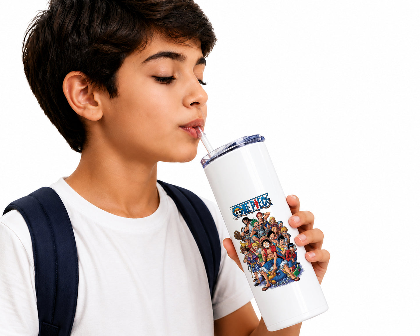 A young boy with short dark hair, wearing a white t-shirt and a navy backpack, is shown drinking from a white insulated tumbler with a clear lid. The tumbler features a colorful graphic print of the anime series One Piece, including characters and the series logo.
