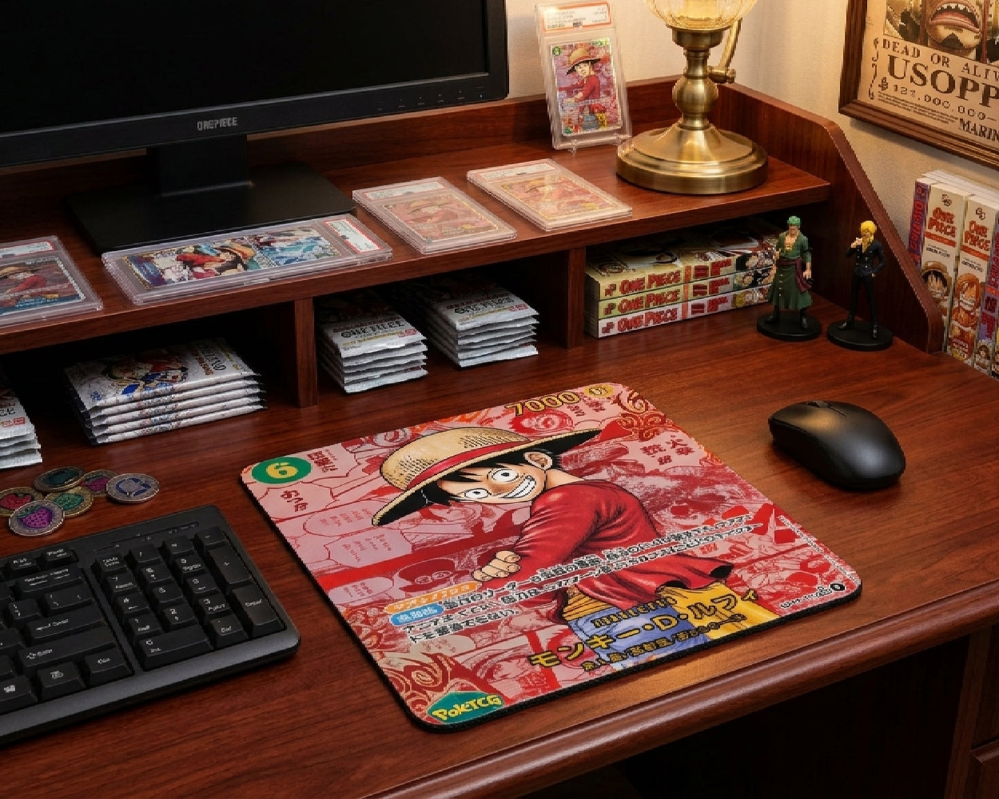 One Piece collector themed gaming desk featuring a Luffy anime mouse pad, manga volumes, trading card slabs, anime figurines, and warm wooden workstation aesthetic