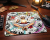 Anime gaming workspace featuring a Gear 5 Luffy manga panel mouse pad, RGB gaming mouse, pirate themed desk decor, and warm One Piece inspired aesthetic