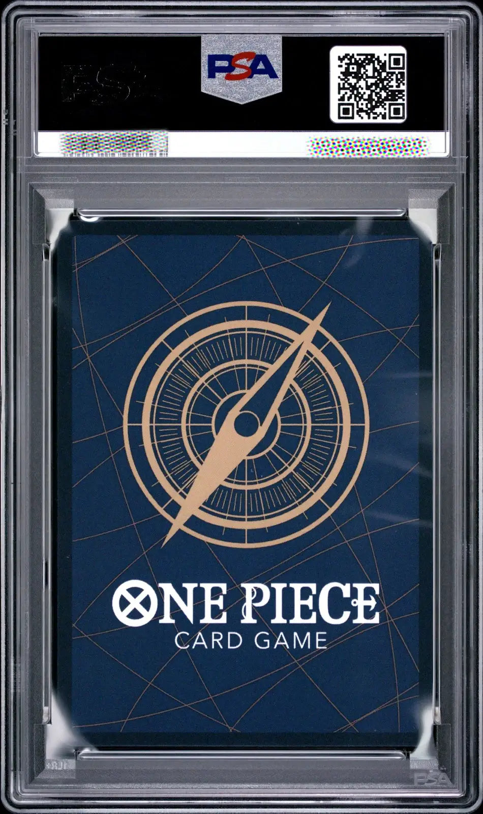 A PSA graded One Piece Card Game deck box or card sleeve inside a clear plastic grading case, with a dark blue design and gold compass graphic.