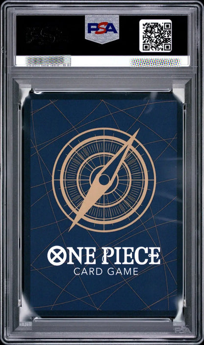 A PSA graded One Piece Card Game deck box or card sleeve inside a clear plastic grading case, with a dark blue design and gold compass graphic.