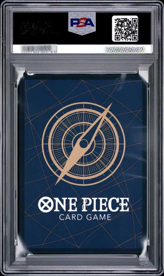 A PSA graded One Piece Card Game deck box or card sleeve inside a clear plastic grading case, with a dark blue design and gold compass graphic.