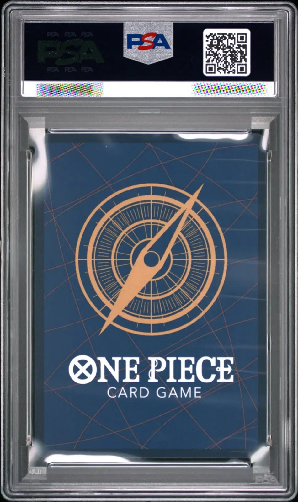 A PSA graded One Piece Card Game card pack inside a clear plastic grading case, with a dark blue card sleeve featuring a gold compass design and white One Piece branding.