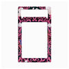 A decorative rectangular phone case frame with a black background, pink and magenta baroque scrollwork, and white rose motifs, shown on a plain white background.