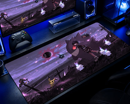 A large gaming desk mat featuring an anime-style illustration of a dark wolf-like character and Pokémon, displayed on a desk in a gaming setup alongside a controller, monitor, and speakers.