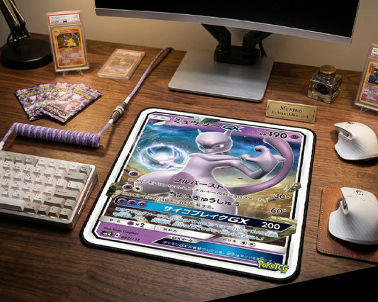Pokémon themed gaming desk featuring Mewtwo GX card style mouse pad, mechanical keyboard, collectible Pokémon cards, braided keyboard cable, and dual wireless mouse setup
