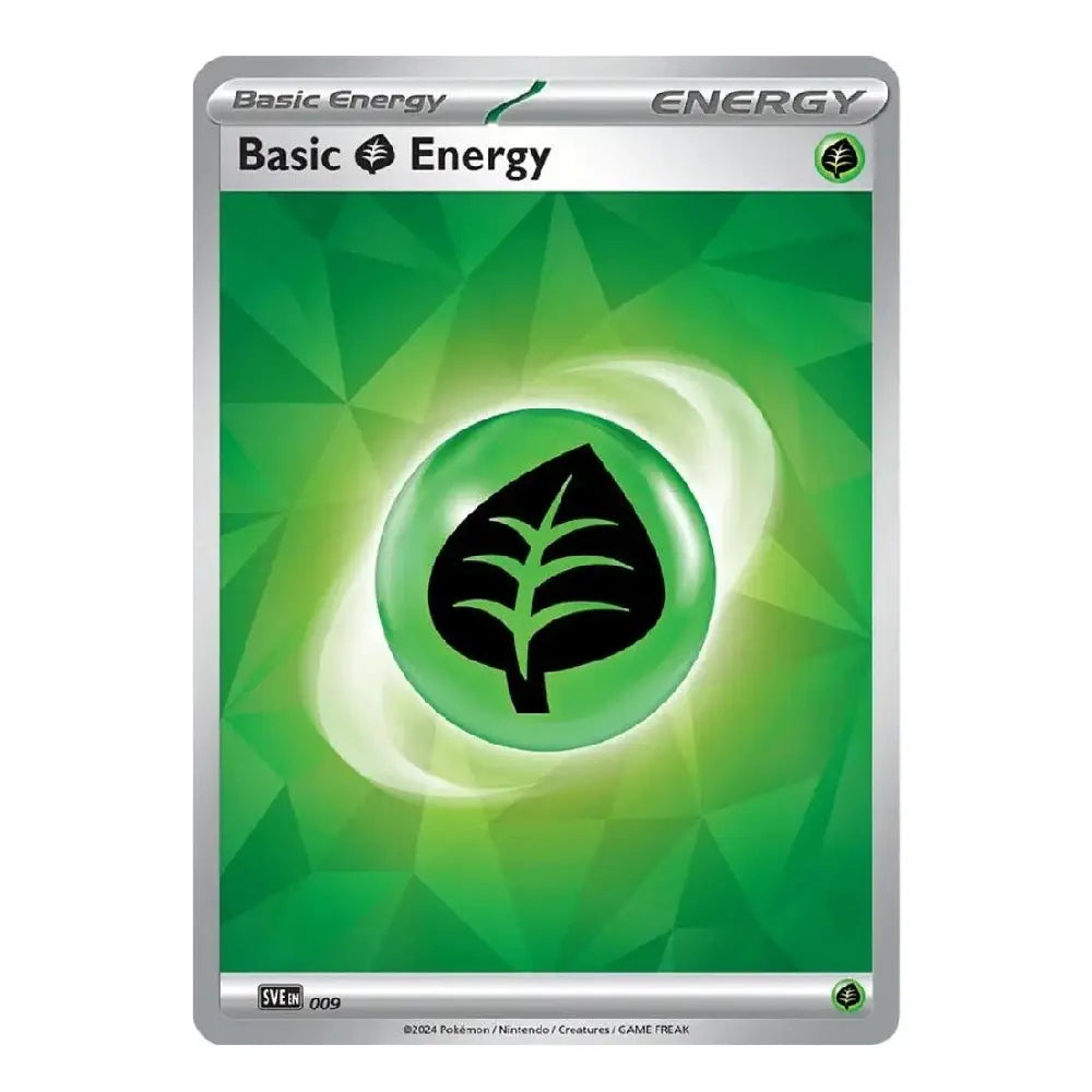 A single trading card featuring the text 'Basic Energy' at the top, with a green geometric design and a central green leaf icon inside a glowing circle. The card has a silver border and small printed text along the bottom.