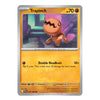 A single Pokémon trading card for Trapinch from the Basic set, shown against a plain white background. The card features a yellow-orange lower text area, a silver border, and artwork of the character Trapinch in a purple-toned room.