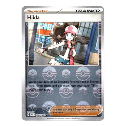 A Pokémon trading card featuring Hilda, a Supporter Trainer card from the 2024 TCG Expansion Year 1 Set. The card has a silver border, a silver-gray text box with Pokéball icons, and an illustration of Hilda in a pink and white cap, brown hair, and a black vest.