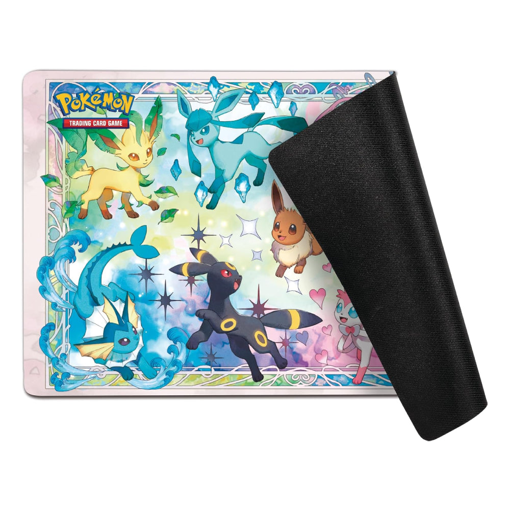 Pokémon Trading Card Game playmat featuring colorful artwork of Eevee and other Eevei family Pokémon, with a black textured backing sheet partially peeled off on the right, shown on a white background.