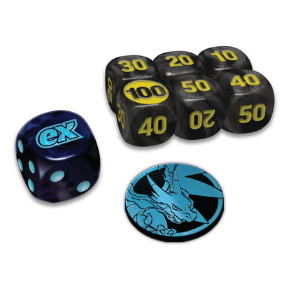 A set of gaming dice and a coin featuring the Exalted character design. The set includes a dark blue marbled die with a cyan 'ex' logo, a cluster of black polyhedral dice with yellow numbering, and a circular black and blue coin showing the Exalted dragon illustration.