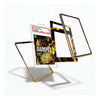 Four smartphone cases floating in mid-air against a white background, each with a gold-toned metal edge. One case features a clear back with a comic book graphic insert, another has a black and gold flame pattern, and two others show black and gold solid designs.