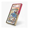 A custom Pokémon trading card case standing upright on a white background. The case features a gold-plated frame with a vibrant pink/magenta back cover and a clear front cover displaying a holographic Pokémon card (Saffred from Scarlet & Violet).