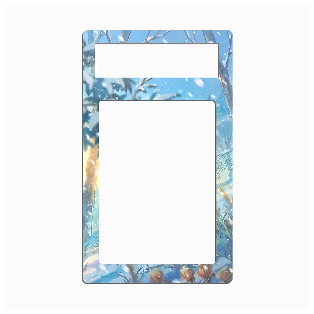 A rectangular decorative frame or mat with rounded corners, featuring a winter forest illustration in shades of blue, white, and soft brown. The design includes snow-covered branches, falling snow, and a warm light on the left side, with two horizontal white cutout slots near the top.