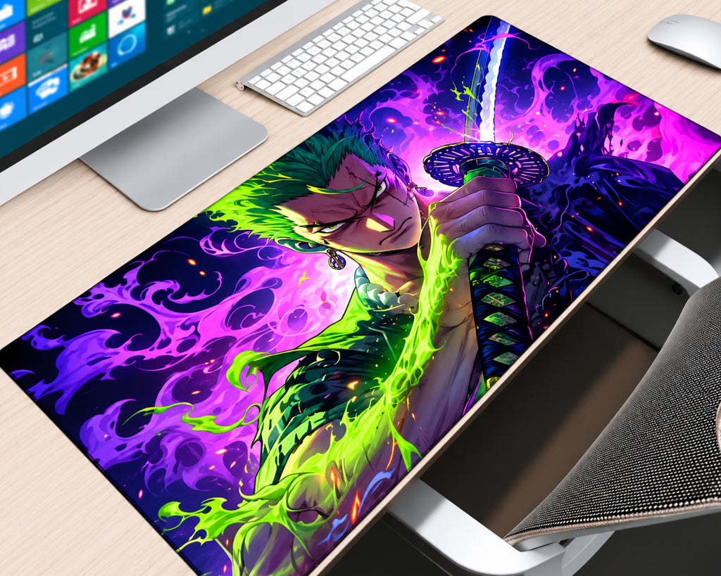 Roronoa Zoro One Piece extended gaming mouse pad featuring the green-haired swordsman holding a katana surrounded by neon-green flames, vibrant purple and magenta energy, and a dark anime background, displayed on a light wood desk with a white keyboard, monitor, and wireless mouse.